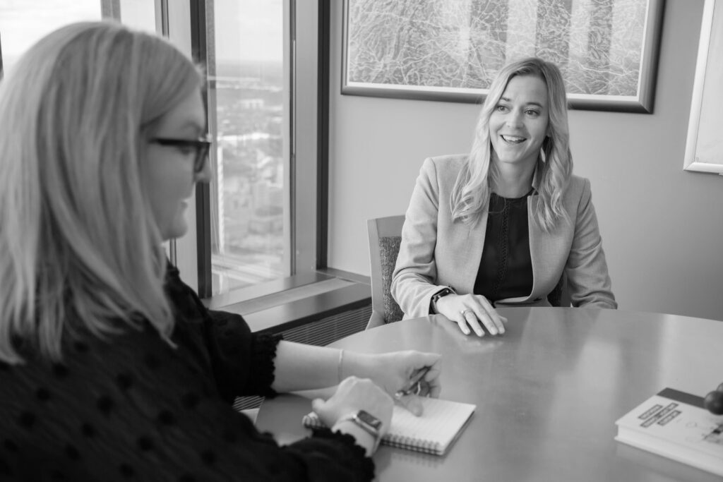 Amy Salmela and Daidre Burgess, Principals at Patterson Thuente IP, working at a conference table