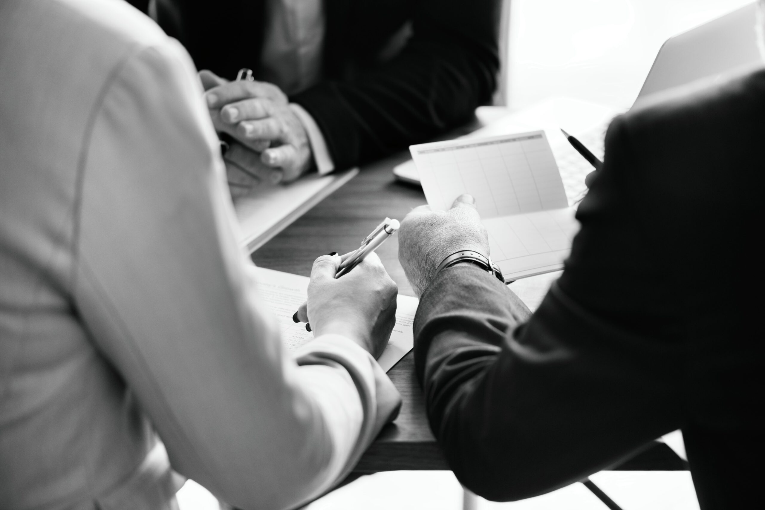 Businesspeople working through a calendar in the conference room